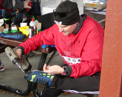 photo of someone installing screws to the bottom of their running shoe
