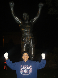 Photo of Jorge in the ROcky pose in Philadelphia.