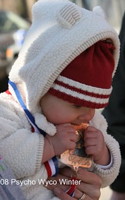 Photo of baby cutting teeth on a Psycho Wyco medal.