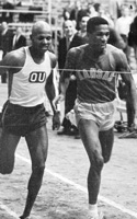 Photo of Ben Olison winning a race at Allen Fieldhouse.
