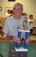 Photo of Dick Wilson holding his trophy for winning the 5K Walk at the Fiesta Mexicana.