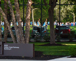 Photo of reflection of runners on Corporate Roods building at the Mothers' Day Run.