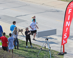 Photo of a couple with their dog finishing the 2013 Race Ipsa 5K.