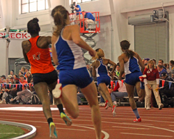 Photo of the women's 600 meter chasing Paris Daniels around the first curve.